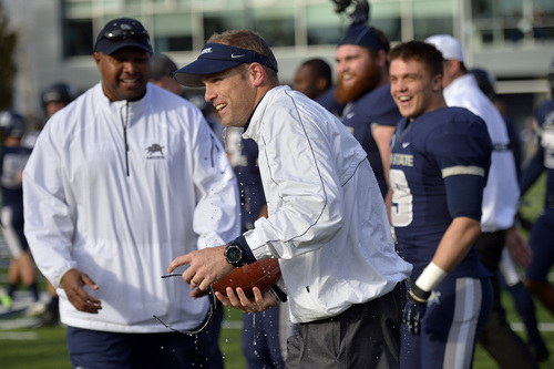 Chris Detrick  |  The Salt Lake Tribune
Utah State Aggies head coach Matt Wells gets water dumped on him after the game at Merlin Olsen Field at Romney Stadium Saturday November 30, 2013.  Utah State defeated Wyoming 35-7. The Aggies will visit Fresno State in the title game next Saturday to complete their first season of MW competition.