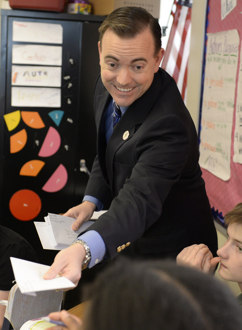 Rick Egan  | The Salt Lake Tribune 

West Valley City Mayor Mike Winder helps sixth-graders at Endeavor Hall Charter School write letters inviting President Obama to visit Utah, Thursday, Dec. 5, 2013.
