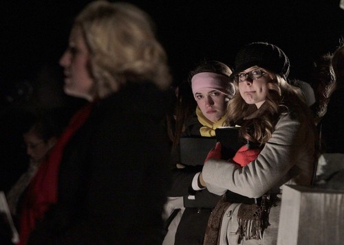 Leah Hogsten  |  The Salt Lake Tribune
Bingham High School Madrigal singers Patrice Densley (center)and Vickie Bentley (right) listen as Jamie Gillman talks about the loss of her infant son Carson Gillman.   Friends and family whose infants and young children have died, gathered at the Christmas Box Angel statue in the Salt Lake City Cemetery for a candlelight vigil in remembrance, December 6, 2013.