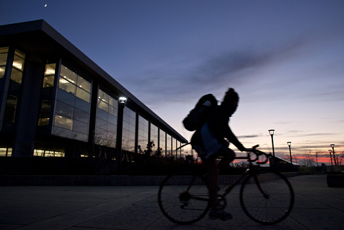 Lennie Mahler  |  The Salt Lake Tribune
A cyclist passes by the Marriott Library on the University of Utah campus at sunset Tuesday, Nov. 29, 2011.