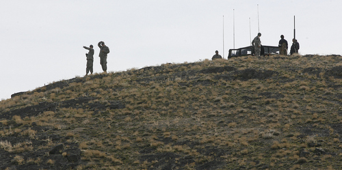 Scott Sommerdorf  |  Salt Lake Tribune
SUSAN POWELL SEARCH
National Guard personnel point as they survey an area near Simpson Springs. Many people came together to help in the search for any sign of Susan Powel, Saturday 4/10/10.