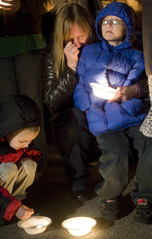 Kim Raff |The Salt Lake Tribune
Kaari Gale becomes emotional while standing with her two sons (left) Joshua and Ethan Gale at a vigil for the Powell family after the explosion at Josh Powells house that kill himself and his two sons, Charlie and Braden, at Oquirrh Hills Elementary in Kearns, Utah on February 5, 2012.  Kaari is sisters with Kiirsi Hellewell who is a close friend of Susan Powell. Her two sons were the same age as Powell's sons who died in the explosion earlier in the day.