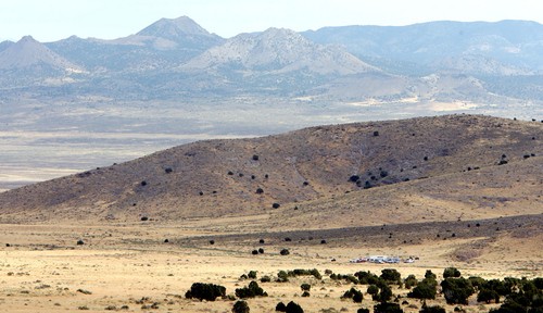 Steve Griffin  |  The Salt Lake Tribune

Law enforcement vehicles are parked off the road, lower right, as authorities continue to search, for Susan Powell, in the area around Topaz Mountain in Juab County about 40 miles north west of Delta, Utah Wednesday, September 14, 2011.