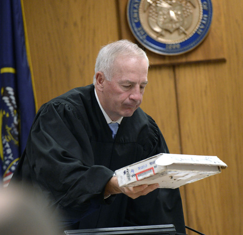 Al Hartmann  |  The Salt Lake Tribune
Judge Samuel McVey looks in evidence box with hand gun in it at Conrad Truman's preliminary hearing in Fourth District Court in Provo Friday December 6.  Truman is charged with the murder of his wife Heidi Truman in September 2012 and obstruction of justice.