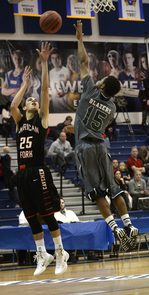 Rick Egan  | The Salt Lake Tribune 

Brayden Harris (25) shoots for the Cavemen, as Austin Conway defends for the Trailblazers, in prep basketball action, American Fork vs. Overland, Colorado  boys' basketball game, in the Great Western Shootout, at Orem High, Friday, December 6, 2013.