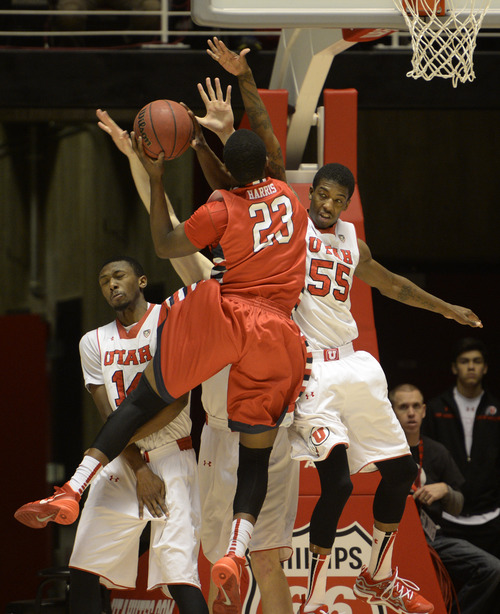 Rick Egan  | The Salt Lake Tribune 

Utah Utes guard Delon Wright (55) defends as Fresno State Bulldogs guard Marvelle Harris (23) takes the ball to the hoop, in basketball action Utah vs. Fresno State, in the Huntsman Center, Saturday, December 7, 2013.Harris was called for charging on the play.
