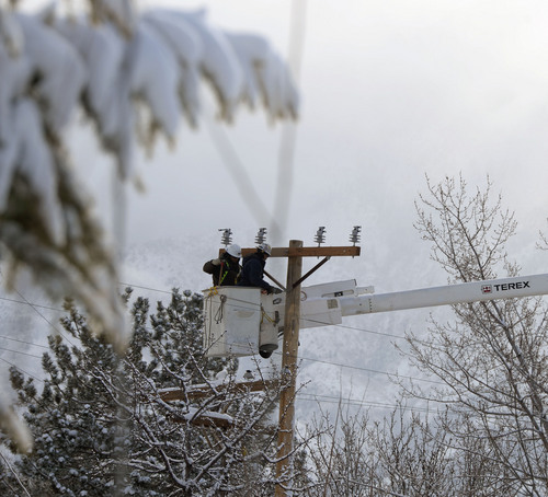Al Hartmann  |  The Salt Lake Tribune
Utlity workers repair a power line in Sugar House Sunday Dec. 8, 2013, after six inches of new snow blanketed the area overnight.