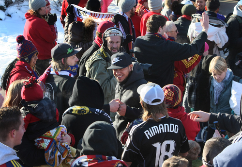 Scott Sommerdorf   |  The Salt Lake Tribune
RSL goalkeeper Nick Rimando gets a knuckle bump from a fan as he makes his way through a sea of fans as he and other Real Salt Lake players and coaches arrive in Salt Lake at the TAC Air sports terminal, Sunday December 8, 2013.