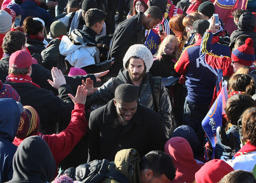 Scott Sommerdorf   |  The Salt Lake Tribune
RSL fans give midfielder Kyle Beckerman high fives as he and other Real Salt Lake players and coaches as they make their way through a sea of fans after arriving in Salt Lake at the TAC Air sports terminal, Sunday December 8, 2013.
