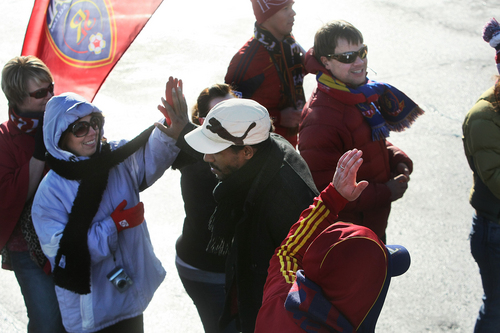 Scott Sommerdorf   |  The Salt Lake Tribune
RSL fans give Real Salt Lake players and coaches high fives as they make their way through a sea of fans after arriving in Salt Lake at the TAC Air sports terminal, Sunday December 8, 2013.