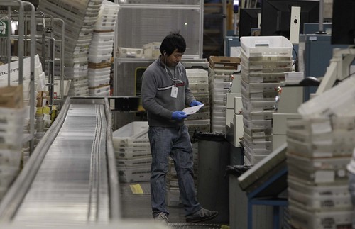 Leah Hogsten  |  The Salt Lake Tribune
USPS clerk Jojo Htut sorts mail December 10, 2013. The United States Postal Service's Salt Lake City main processing center will process over 1.2 million postmarks on the busiest shipping day of the year,  Monday, Dec. 16. Some 800 employees process some 2.4 billion pieces of mail annually and expect a 16% increase in packaging volume in Salt Lake City this holiday season.