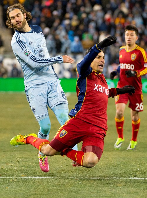 Trent Nelson  |  The Salt Lake Tribune
Real Salt Lake's Tony Beltran (2) gets tripped up by Sporting KC's Graham Zusi (8) as Real Salt Lake faces Sporting KC in the MLS Cup Final at Sporting Park in Kansas City, Saturday December 7, 2013.