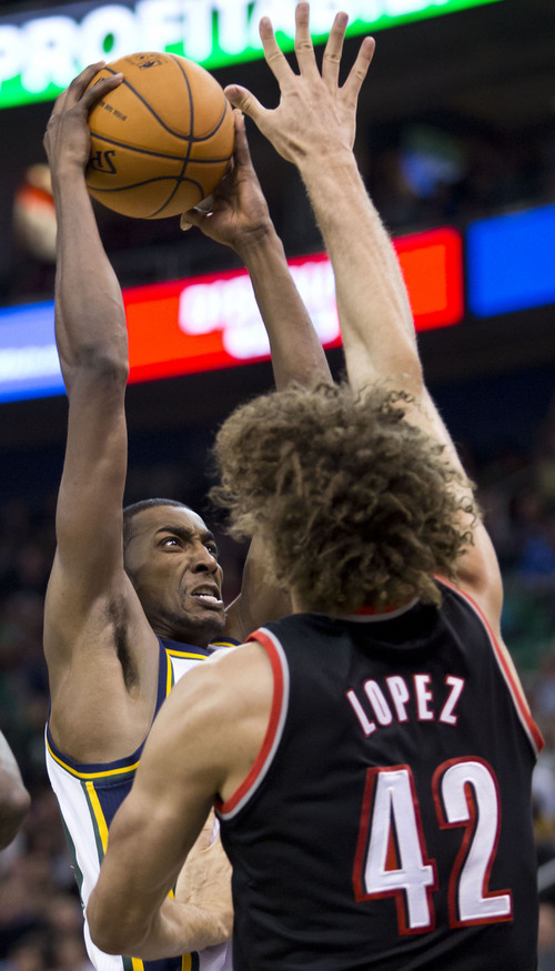 Lennie Mahler  |  The Salt Lake Tribune
Jazz forward Jeremy Evans goes up for a shot over Portland's Robin Lopez in the first half of a game against the Portland Trailblazers on Monday, Dec. 9, 2013.