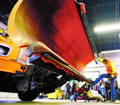 Steve Griffin  |  The Salt Lake Tribune

UDOT maintenance workers change a bent blade on a snowplow as crews get ready for the coming winter storm at the UDOT maintenance yard in Salt Lake City Monday, December 2, 2013.