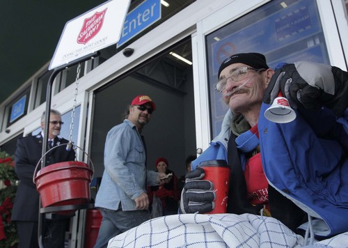 Leah Hogsten  |  The Salt Lake Tribune
Former Ogden Salvation Army employee Douglas Holladay rings the bell December 5, 2013, at the Riverdale Wal-Mart to fill three three red kettles with money for the needy. Holladay has terminal lung cancer and has been told by doctors that he may not live until Christmas, so he told The Salvation Army that he wanted to collect donations one final time.