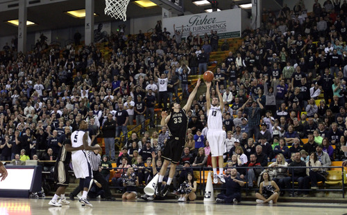 Rick Egan  | The Salt Lake Tribune 

Utah State Aggies guard Preston Medlin (13) shoots a 3-pointer at the buzzer tying the game at 69-69 sending the game into overtime, in basketball action Utah State vs. The Idaho Vandals,  in Logan, Saturday, January 5, 2013.