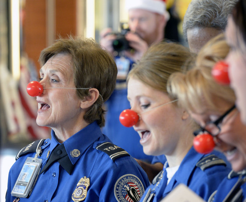 Al Hartmann  |  The Salt Lake Tribune
TSA agents at the Salt Lake City airport sing "Rudolph the Red-Nosed Reindeer" to  20 children from military families who lost a parent in the  wars in Iraq and Afghanistan. American Airlines paid their way on the "Snowball Express" to Dallas for a week's vacation.