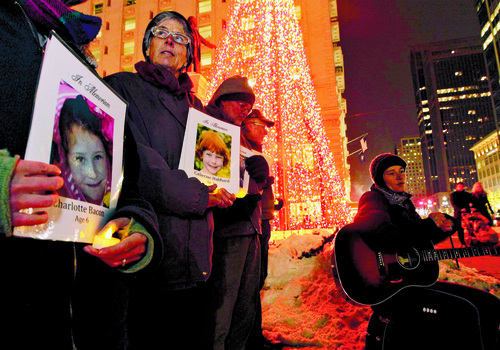 Leah Hogsten  |  The Salt Lake Tribune
Louise Ewing and other Gunsense advocates sing songs and say the names of those who were killed at Sandy Hook Elementary in 2012.  A candlelight vigil marking Saturday's one-year anniversary of the Sandy Hook Elementary shootings, sponsored by Gunsense, Gun Violence Prevention Center and Utah Parents Against Gun Violence, December 13, 2013.