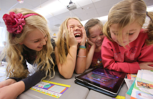 Francisco Kjolseth  |  The Salt Lake Tribune
Freedom Elementary 2nd graders, Avery Sherratt, Kate Durfey, Hannah Dajany and Lilly Adams, from left, crack up when the movements of their robot don't go as planned while using code instruction on an iPad on Tuesday, Dec. 10, 2013 in Highland, Utah. This week schools across the country are participating in Hour of Code, teaching kids about computer coding through fun games.