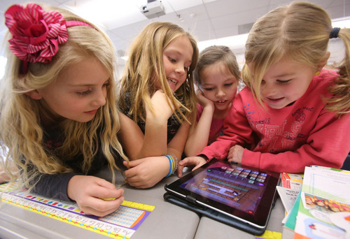 Francisco Kjolseth  |  The Salt Lake Tribune
Freedom Elementary 2nd graders, Avery Sherratt, Kate Durfey, Hannah Dajany and Lilly Adams, from left, work together to move a robot using code instruction on an iPad on Tuesday, Dec. 10, 2013 in Highland, Utah. This week schools across the country are participating in Hour of Code, teaching kids about computer coding through fun games.