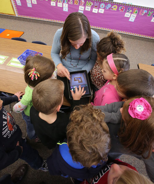 Francisco Kjolseth  |  The Salt Lake Tribune
Kindergarten teacher Rebecca Calton gets kids started on a mobile device using simple games to learn computer coding at Freedom Elementary in Highland Utah on Tuesday, Dec. 10, 2013. This week schools across the country are participating in Hour of Code, teaching kids about computer coding through fun games.