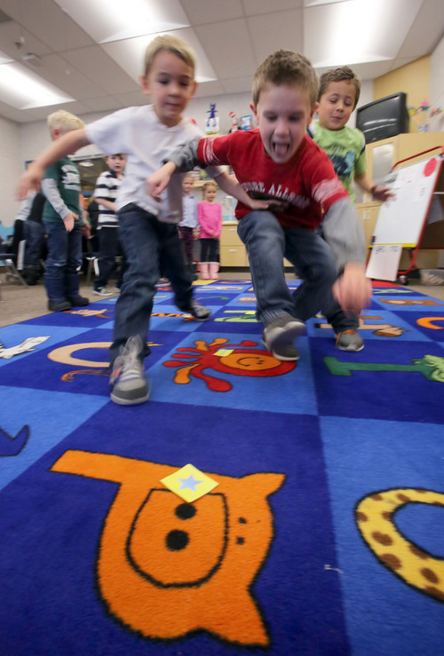 Francisco Kjolseth  |  The Salt Lake Tribune
Freedom Elementary kindergartners Josh Stratford, Brecken Webecke and Titan Harris, from left, jump at the chance to move a piece in a game designed to learn about computer coding in Highland Utah on Tuesday, Dec. 10, 2013. This week schools across the country are participating in Hour of Code, teaching kids about computer coding through fun games.