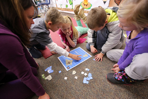 Francisco Kjolseth  |  The Salt Lake Tribune
Parent teacher Sarah Thomas watches as second graders from Freedom Elementary in Highland Jacob Hedrickson, Elisa Jones, Gabe Robertson and Olivia Peterson, from left, figure out how to move in the direction of the treasure on Tuesday, Dec. 10, 2013. This week schools across the country are participating in Hour of Code, teaching kids about computer coding through fun games.