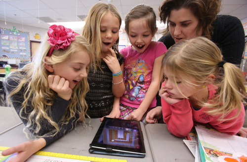 Francisco Kjolseth  |  The Salt Lake Tribune
Freedom Elementary 2nd graders, Avery Sherratt, Kate Durfey, Hannah Dajany and Lilly Adams, from left, get some pointers on how to move a robot using code instruction on an iPad from teacher Amy Cox on Tuesday, Dec. 10, 2013 in Highland Utah. This week schools across the country are participating in Hour of Code, teaching kids about computer coding through fun games.