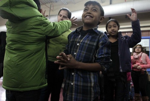 Leah Hogsten  |  The Salt Lake Tribune
Noe Torres, 8, can't contain his excitement as he waits to slip into his new winter coat along with his brother Natanaly, 9, (left) and sister Jennifer, 11, right.   The Utah Knights of Columbus put warm smiles on hundreds of children, Saturday, December 14, 2013 during the 4th annual Coats for Kids, a national campaign expected to donate more than 40,000 new coats to children in need in cold-weather cities. To donate: go to http://www.utahknights.org/donate