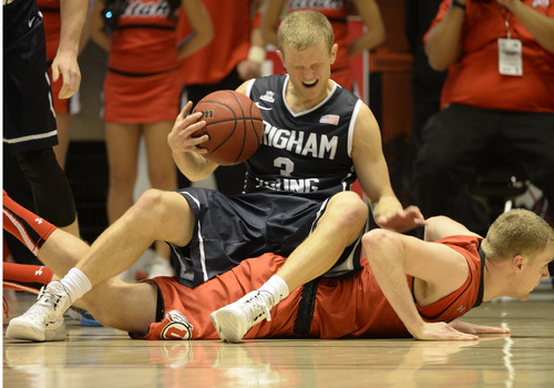 Rick Egan  | The Salt Lake Tribune 

Brigham Young Cougars guard Tyler Haws (3) lands on on of the Utah Utes after her was fouled, in basketball action, at the Huntsman Center, Saturday, December 14, 2013.