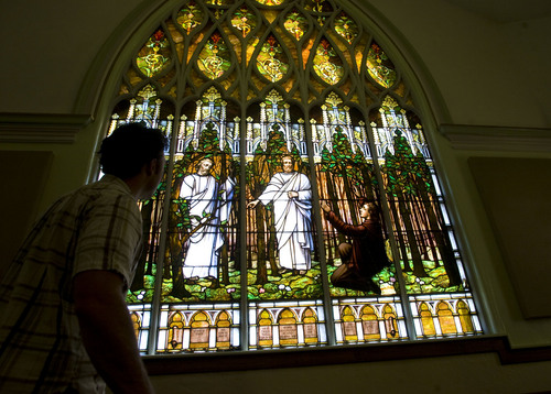 The Salt Lake Second Ward at 704 S. 500 E. shows a distinctive Gothic Revival style with a corner tower.  It's  stained-glass window of Joseph Smith's First Vision is awe inspiring.  Clayton Vance, a graduate student in architecture at Notre Dame looks at the window from inside the chapel.    Al Hartmann/The Salt Lake Tribune   7/12/2009