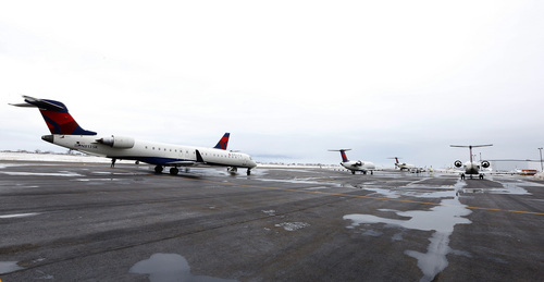 Several Delta planes sit on the ground at the Provo Airport on December 19, 2013 in Provo, Utah. Several Delta flight were diverted and landed at the Provo Airport after the Salt Lake City a Airport was closed standing several hundred passengers.  (Photo by George Frey  |  Special to the Tribune)
