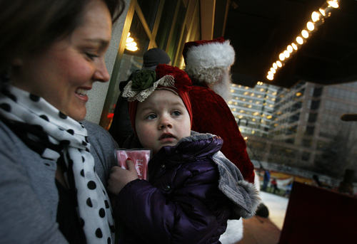 Scott Sommerdorf   |  The Salt Lake Tribune
Presely Clavine wiats with her mother Alyssa Clavine for her moment to tunr on the Christmas tree lights along with Santa as a part of the Make a Wish Foundation while at the Gallivan Center skating rink, Friday November 29, 2013.