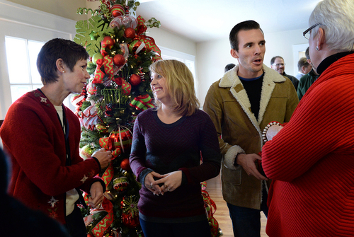 Scott Sommerdorf   |  The Salt Lake Tribune
Megan and Dustin Olsen, center, entertained guests who attended the open house in their new home to celebrate the completion of the 100th home rehabilitated by Ogden City's Community Development division in partnership with HUD, Wednesday December 18, 2013.