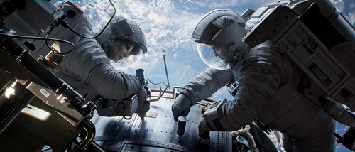 This publicity photo released by Warner Bros. Pictures shows Sandra Bullock, left, as Dr. Ryan Stone and George Clooney as Matt Kowalsky in "Gravity." (AP Photo/Courtesy Warner Bros. Pictures)