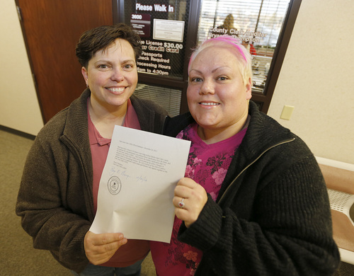 Raylynn Marvel left, and Patsy Carter right, from Orem, Utah, leave the offices of the Utah County Clerk and Auditor office and hold a rejection letter for a marriage license on Dec. 20, 2013 in Provo, Utah. A federal judge on Friday struck down Utah's ban on same sex marriage saying the law violates the U.S. Constitution.  (Photo by George Frey  |  Special to the Tribune)