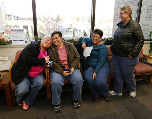 Raylynn Marvel left, Patsy Carter, 2nd left, from Orem, Utah, Loreen Major 2nd right, and Arlene Arnold right, from Lehi, Utah wait in the offices of the Utah County Clerk and Auditor office for word if they will be issued a marriage license as a lesbian couple on Dec. 20, 2013 in Provo, Utah. A Federal Judge on Friday struck down Utah's ban on same sex marriage saying the law violates the U.S. Constitution.  (Photo by George Frey  |  Special to the Tribune)