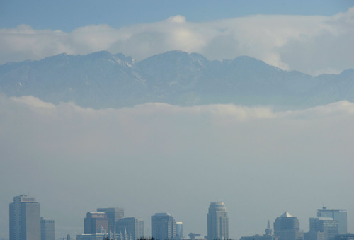 Steve Griffin  |  The Salt Lake Tribune

The snow-covered Wasatch Mountains peek out from the cloud cover over Salt Lake City Friday, Dec. 20, 2013.