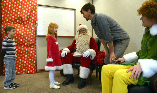 Steve Griffin  |  The Salt Lake Tribune

James Good, 6, and Shayla Brown, 7, meet Santa at VitalSmarts in Provo Friday, December 20, 2013. The founder of the Utah company, Joseph Grenny, is running an experiment with kids and Santa. Grenny, coauthor of the NY Times bestselling book "Crucial Conversations," says the study reveals that how we talk about Christmas can have a big impact on how kids approach gifts, giving and gratitude. Good and Brown were part of a control group during the experiment. Here Chase McMillan, of Vital Smarts, explains to the children their role in the experiment.