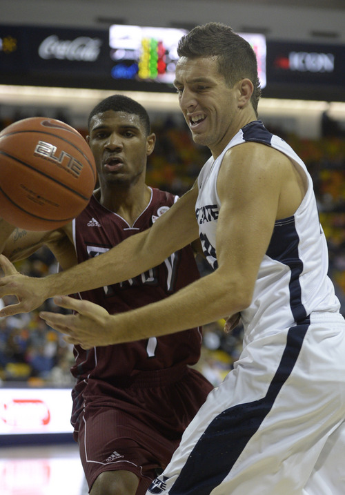 Rick Egan  | The Salt Lake Tribune 

Utah State Aggies guard/forward Spencer Butterfield (21) has the ball knocked away by  Troy Trojans guard Antoine Myers (1) defends, in basketball action, Utah State vs.Troy, at the Dee Glen Smith Spectrum, in Logan, Friday, December 20, 2013.