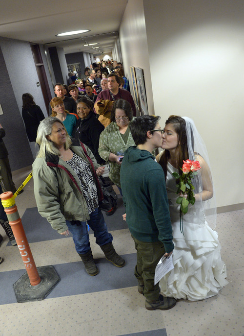 Francisco Kjolseth  |  The Salt Lake Tribune
Heather Collins, in dress, gets ready to marry her partner of 6-years Jax Collins as they join hundreds of same-sex couples who descended on county clerk offices around the state of Utah on Monday, Dec. 22, 2013,  including the Salt Lake County office to request marriage licenses. A federal judge in struck down the state's ban on same-sex marriage last Friday, saying the law violates the U.S. Constitution's guarantees of equal protection and due process.