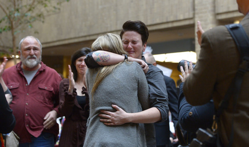 Francisco Kjolseth  |  The Salt Lake Tribune
Jamie Stocks is overcome with emotion as she embraces her wife Jessica Hamilton after being married in the lobby of the Salt Lake County offices on Monday, Dec. 23, 2013. Hundreds of same-sex couples descended Salt Lake County offices to request marriage licenses. A federal judge in Utah struck down the state's ban on same-sex marriage last Friday, saying the law violates the U.S. Constitution's guarantees of equal protection and due process.