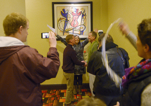 Steve Griffin  |  The Salt Lake Tribune


Rev. Monica Hall, of Trinity Presbyterian Church in Ogden, holds up her hands up as she announces Mark Marinan and Jeff poor officially married at the Hampton Inn Suites in Ogden, Utah Monday, December 23, 2013 Volunteer clergy were performing marriage ceremonies for couples across the street from the Weber County Clerk's Office in downtown Ogden.