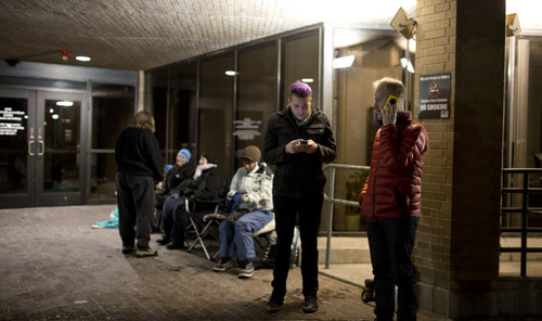 Lennie Mahler  |  The Salt Lake Tribune
Austin Smith and Arlo Vance stand in line with other same-sex couples and supportive friends at the door of the Salt Lake County Government Complex, Sunday, Dec. 22, 2013, to try to obtain marriage licenses from the clerk's office upon its opening Monday morning.