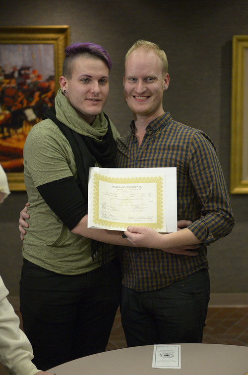 Francisco Kjolseth  |  The Salt Lake Tribune
Austin Smith, left, and Arlo Vance who have been together 8-years make their union official as they join hundreds of same-sex couples who descend on county clerk offices around the state of Utah on Monday, Dec. 22, 2013,  including the Salt Lake County office to request marriage licenses. A federal judge in struck down the state's ban on same-sex marriage last Friday, saying the law violates the U.S. Constitution's guarantees of equal protection and due process.