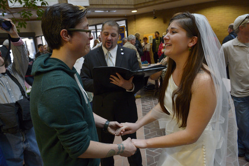 Francisco Kjolseth  |  The Salt Lake Tribune
Jax Collins, left, and Heather Collins become emotional as they are married by Rev. Christopher Scuderi of Universal Heart Ministry on Monday, Dec. 23, 2013, at the Salt Lake City County offices. Hundreds of same-sex couples descended on county clerk offices around the state of Utah to request marriage licenses. A federal judge in Utah struck down the state's ban on same-sex marriage last Friday, saying the law violates the U.S. Constitution's guarantees of equal protection and due process.