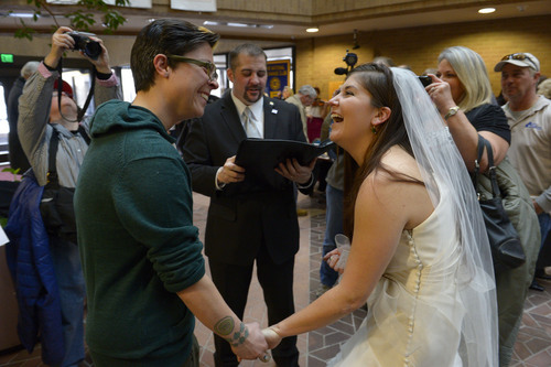 Francisco Kjolseth  |  Tribune file photo
Jax Collins, left, and Heather Collins are overjoyed as they are married by Rev. Christopher Scuderi of Universal Heart Ministry on Monday, Dec. 23, 2013, at the Salt Lake City County offices.