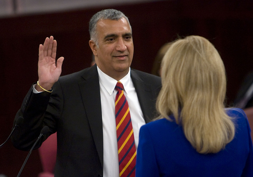 Al Hartmann  |  The Salt Lake Tribune 
Newly elected District Attonrey Sim Gill takes the oath of office from Salt Lake County recorder Sherrie Swenson at a Salt Lake County Inauguration Ceremony Monday morning.  He was among a dozen independent elected officials and Salt Lake County Council members  sworn in for the county.