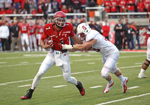 Utah quarterback Travis Wilson (7) attempts to break a tackle from Stanford linebacker Trent Murphy, right, during the second half of an NCAA college football game on Saturday, Oct. 12, 2013, in Salt Lake City. Utah won 27-21. (AP Photo/Rick Bowmer)
