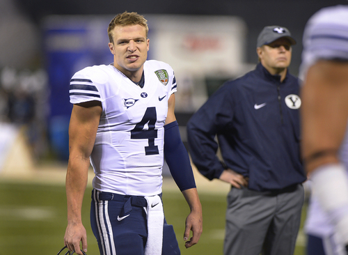 Scott Sommerdorf   |  The Salt Lake Tribune
Brigham Young Cougars quarterback Taysom Hill (4) and head coach Bronco Mendenhall, right, during  pre game warm ups at the Fight Hunger Bowl at AT&T Park in San Francisco, Friday December 27, 2013.